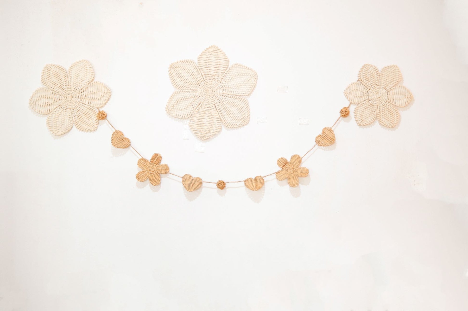 Rattan and felt daisy garland for kids' room decor and baby party, perfect for adding a boho theme.