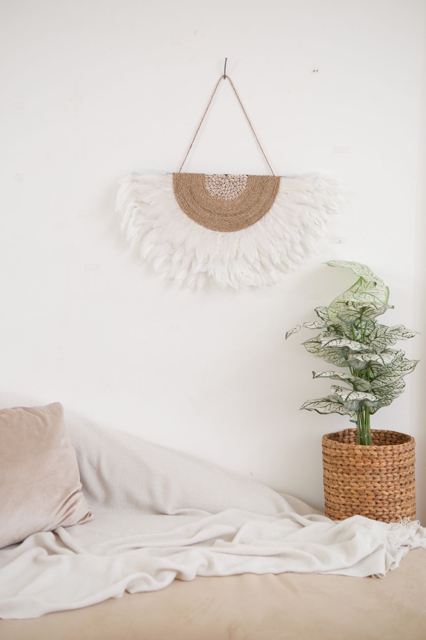 White Juju Hat Wall Decor featuring soft feathers and sea shell accents, perfect for boho beach bedroom, living room decor. Adds a natural, coastal vibe to any space with its textured, handcrafted design.