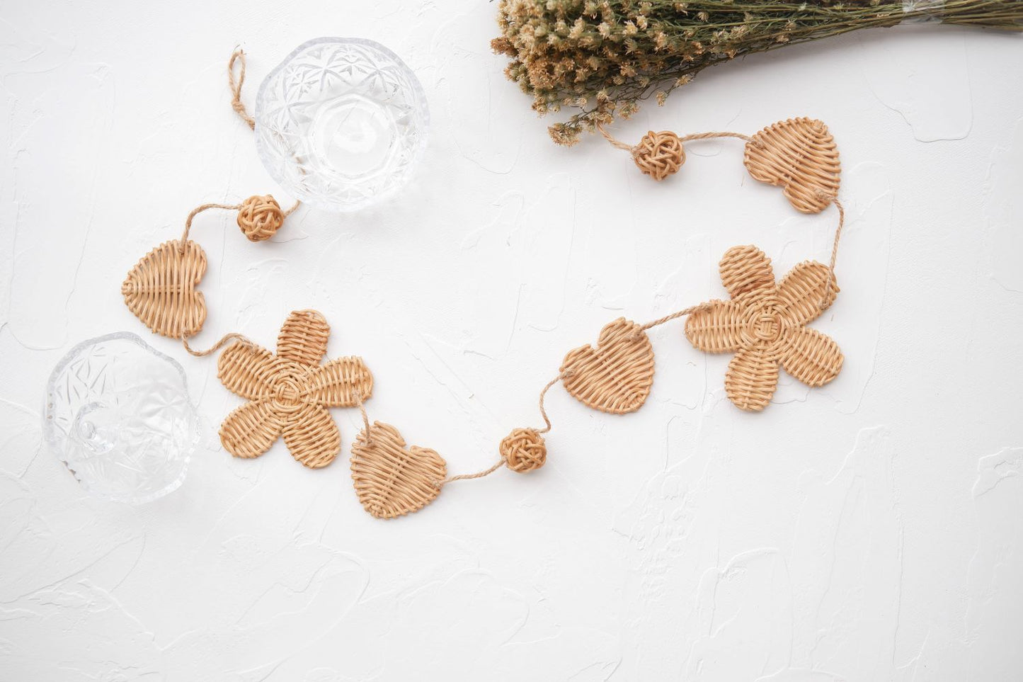 Rattan and felt daisy garland for kids' room decor and baby party, perfect for adding a boho theme.