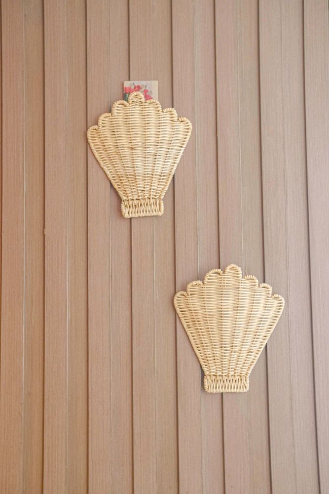 Rattan She Shell Nursery Wall Decor hanging on a wall in a coastal-themed room, with seashells and beach-inspired artwork surrounding it, demonstrating its ability to bring boho beach and coastal vibes into the space