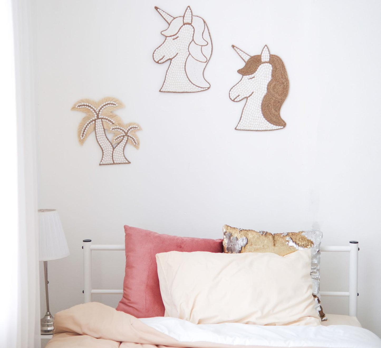 Unicorn wall decor made from white seashells, perfect for boho beach themes, as well as coquette nursery and little girls' rooms.