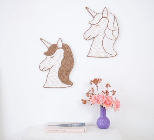 Unicorn wall decor made from white seashells, perfect for a boho or coquette-themed nursery and little girl's room